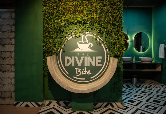 The Divine Bite logo wall inside the cafe