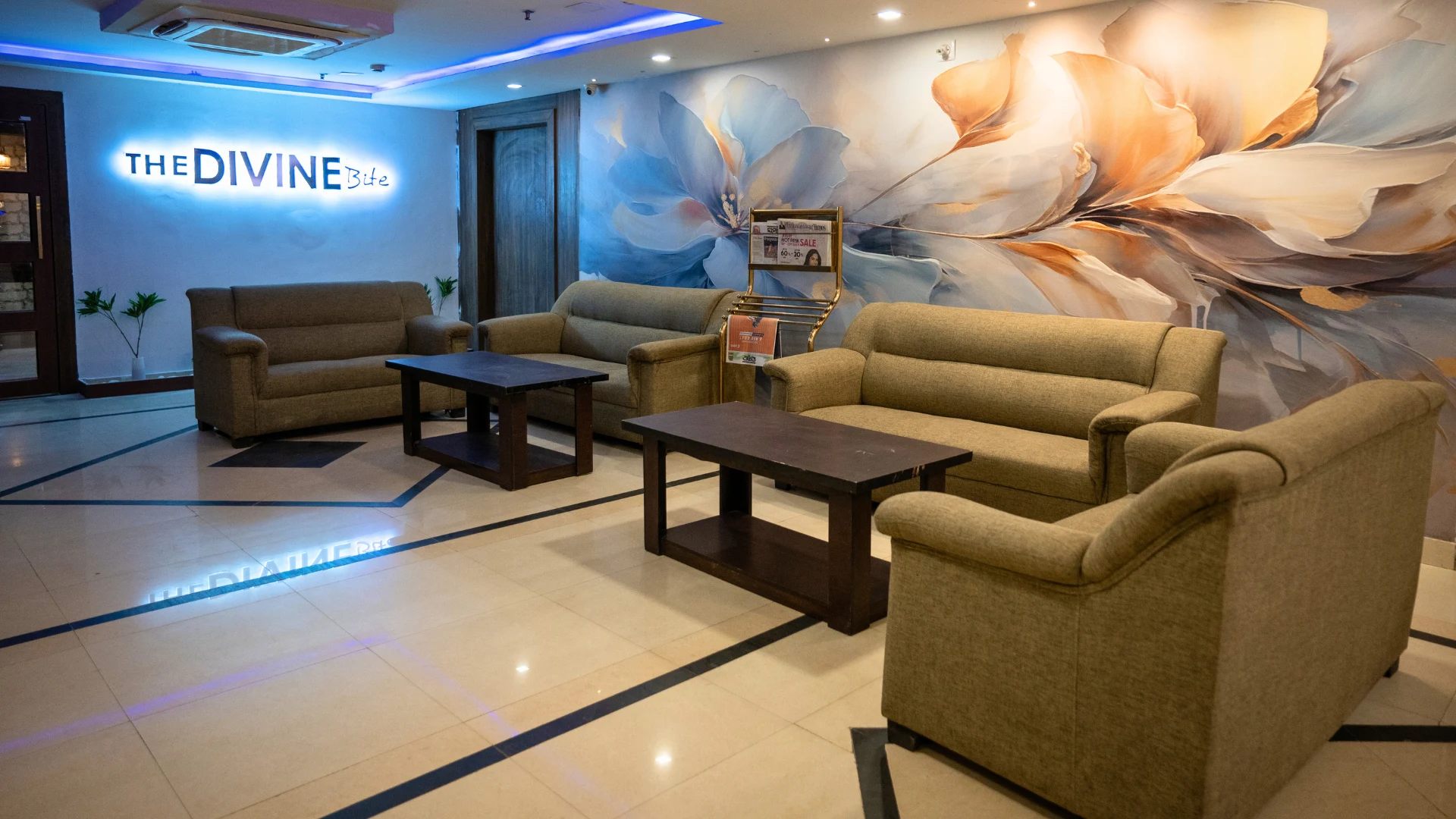 Hotel Shubham Grand lobby with seating and The Divine Bite signage