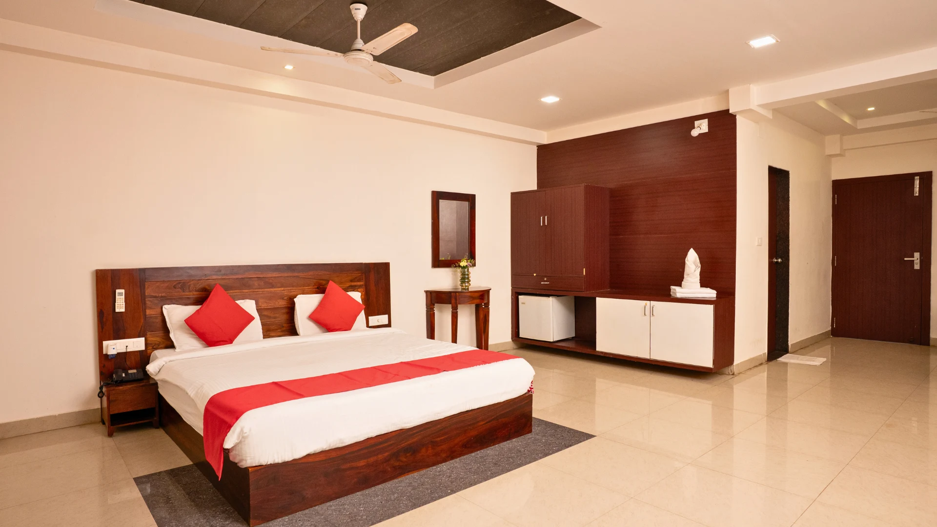 Guest room with king bed, wardrobe and seating at Hotel Shubham Grand, Patia