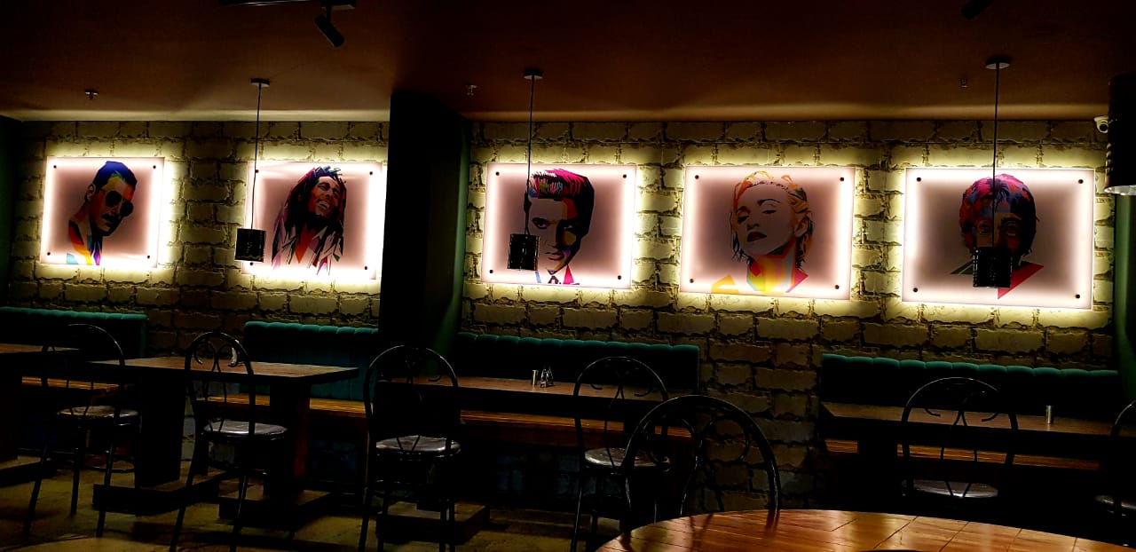 Seating and backlit artwork at Ozen Bar & Kitchen